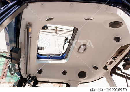 Interior View of Off Road Vehicle Ceiling with Open Sunroof and White Trim in Bright Daylight Interior View of Off Road Vehicle Ceiling with Open Sunroof and White Trim in Bright Daylight 140016479