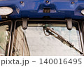 Close up of blue tractor windshield with wiper and modern camera sensor for agricultural technology 140016495