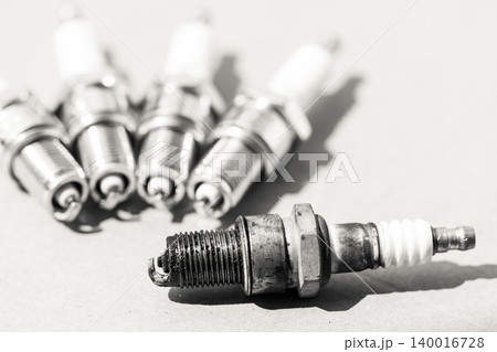 Auto service. Set of spark plugs as spare part of car. Auto service. Set of spark plugs as spare part of car. 140016728