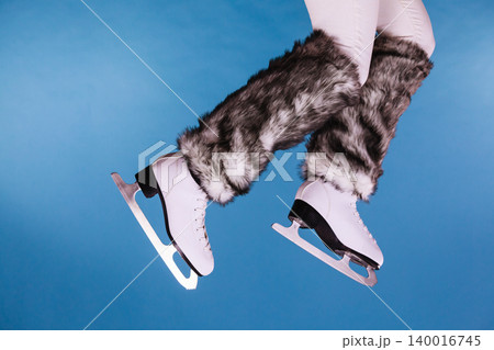 Woman legs wearing ice skates fur socks, skating 140016745