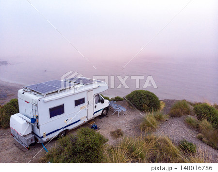 Caravan with solar panels on roof on coast, Spain. Aerial view. Caravan with solar panels on roof on coast, Spain. Aerial view. 140016786