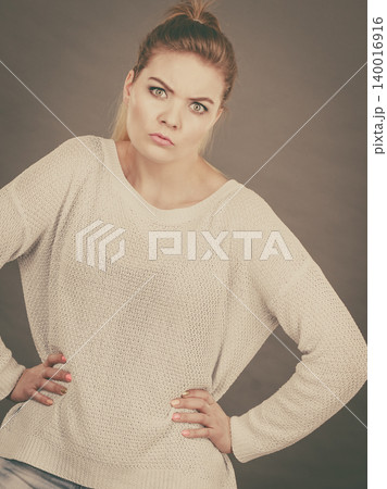 Confused young blonde woman looking suspicious Confused young blonde woman looking suspicious 140016916