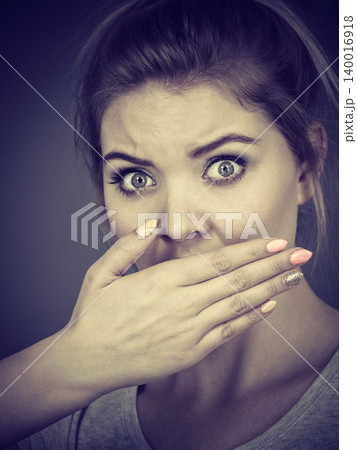 Woman covering her mouth with hand Woman covering her mouth with hand 140016918