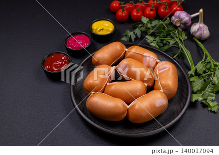 Raw mini sausages with condiments and fresh herbs Raw mini sausages with condiments and fresh herbs 140017094
