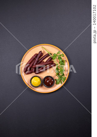 Smoked sausages served with mustard, bbq sauce, and parsley Smoked sausages served with mustard, bbq sauce, and parsley 140017102