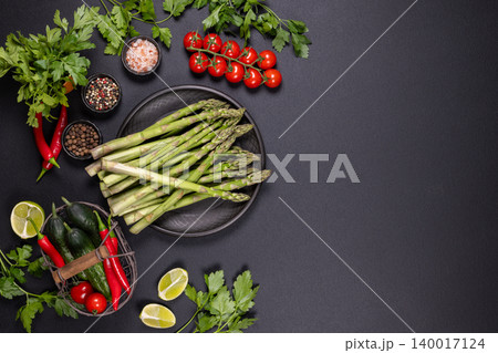 Fresh asparagus and vegetables with spices cooking ingredients Fresh asparagus and vegetables with spices cooking ingredients 140017124