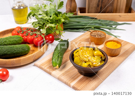 Preparing fresh vegetables and homemade pickles for salad 140017130