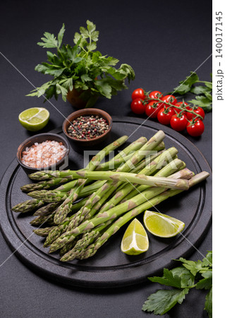 Fresh green asparagus spears with healthy ingredients Fresh green asparagus spears with healthy ingredients 140017145