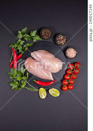 Raw chicken breasts preparing with fresh spices and vegetables Raw chicken breasts preparing with fresh spices and vegetables 140017149