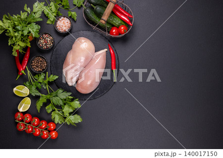 Raw chicken breasts and fresh cooking ingredients 140017150