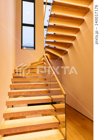 Wooden staircase with minimalist interior architecture and warm light Wooden staircase with minimalist interior architecture and warm light 140017176