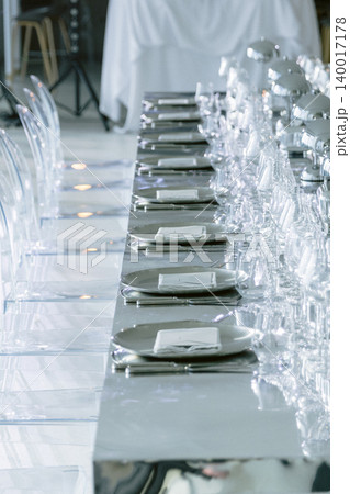 Banquet table with elegant place settings and crystal glasses Banquet table with elegant place settings and crystal glasses 140017178