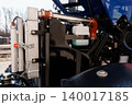 Close up of heavy duty tractor engine components and radiator with blue chassis and metal textures 140017185