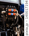Close Up of Hydraulic Control Valves and Black Rubber Hoses on Blue Agricultural Tractor Machine 140017194