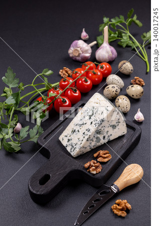 Blue cheese on cutting board with cherry tomatoes and ingredients 140017245