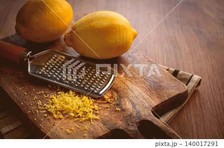 lemons and grated orange peel, with a zest grater, on a chopping board, close-up, no people, lemons and grated orange peel, with a zest grater, on a chopping board, close-up, no people, 140017291