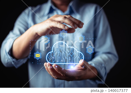 A person holding a glowing digital cloud icon representing cloud computing, data security, storage, and modern technology solutions for business innovation and seamless digital transformation. 140017377