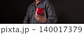 Man hand holding red heart shape on dark background. Concept of love, healthcare, medical insurance and charity donation. Valentine's day symbol for romantic relationship and kindness support. 140017379