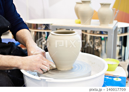 Hands of master in pottery workshop Hands of master in pottery workshop 140017709