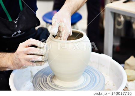Hands of master in pottery workshop 140017710