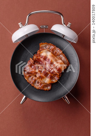 Fried fresh bacon slices with layers of meat or prosciutto with salt and spices. Fried bacon 140017809