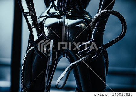 Bdsm style woman in black latex with whip 140017829