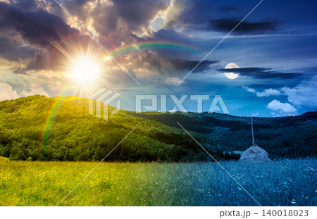 rural fields near mountain in summertime. day meet night. beautiful view of agricultural area. sun and moon in harmony over gorgeous mountain ridge with haystack on a grassy pasture. summer solstice 140018023