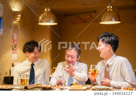 飲み会で若手社員に熱く語る管理職の男性 140018127