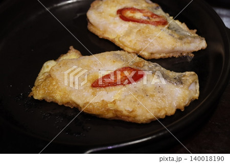 Fried Fish with Chili Slices on Pan Fried Fish with Chili Slices on Pan 140018190