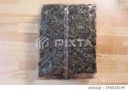 Packaged Seaweed Sheets on Wooden Surface Packaged Seaweed Sheets on Wooden Surface 140018194