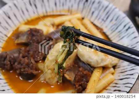 Chopsticks Picking Vegetable from Savory Bowl Chopsticks Picking Vegetable from Savory Bowl 140018254