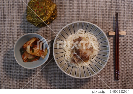 Noodle Bowl with Side Dish and Chopsticks on Textured Table Noodle Bowl with Side Dish and Chopsticks on Textured Table 140018264
