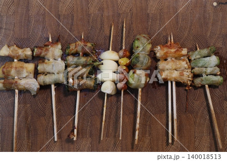 Grilled Skewered Appetizers on Wooden Surface Grilled Skewered Appetizers on Wooden Surface 140018513
