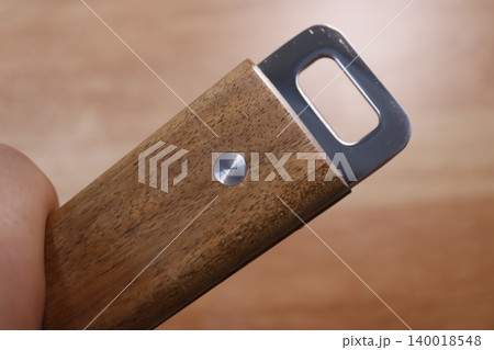 Wooden Handle with Metal Component Close-up 140018548