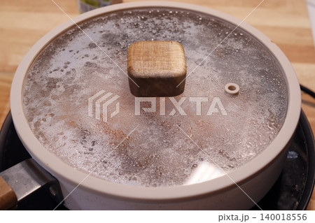 Steaming Pot Lid on Stovetop Steaming Pot Lid on Stovetop 140018556