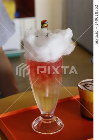 Cocktail with Cotton Candy and Candy Garnish Cocktail with Cotton Candy and Candy Garnish 140018562