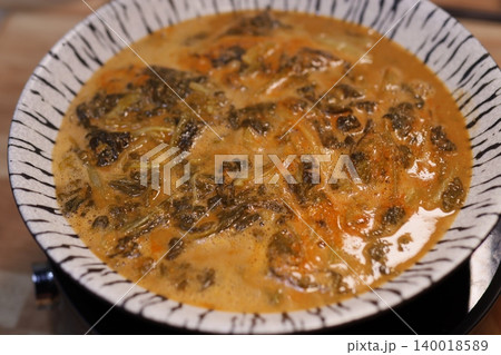Steaming Vegetable Soup in Zebra-Print Bowl 140018589