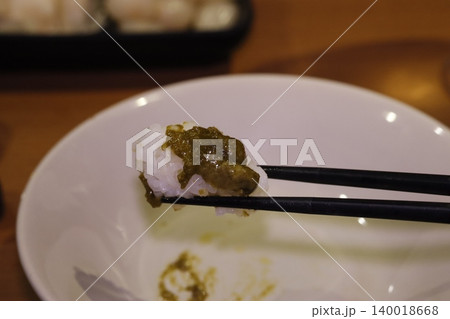 Rice with Green Sauce on Chopsticks 140018668