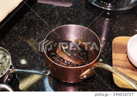 Caramelized Onions in Copper Pot on Stovetop Caramelized Onions in Copper Pot on Stovetop 140018727