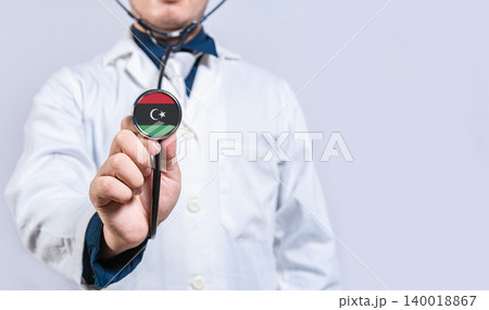 Hands doctor holding stethoscope with Libya flag. Libya health and care concept Hands doctor holding stethoscope with Libya flag. Libya health and care concept 140018867
