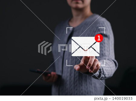Email marketing concept. Woman touching digital envelope icon showing new message notification badge representing corporate newsletter communication, online contact, mobile mail, inbox reminder, 140019033