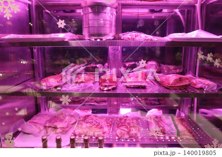 Purple-Lit Meat Display Case with Snowflake Decorations Purple-Lit Meat Display Case with Snowflake Decorations 140019805