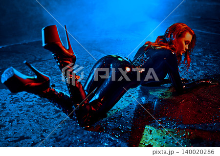 Bdsm style woman in black latex posing in aqua studio 140020286