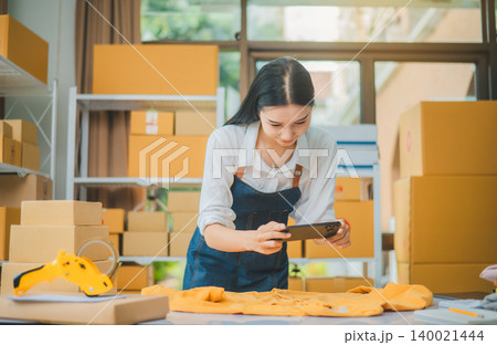 Small business owners online are taking pictures of their products and offering them to customers who will place their orders. - online shopping Small business owners online are taking pictures of their products and offering them to customers who will place their orders. - online shopping 140021444