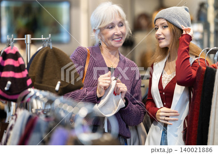 Elderly and young women choosing hat 140021886