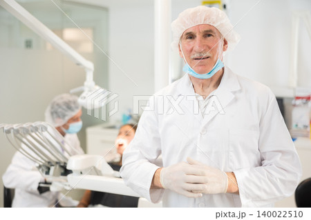 Senior man doctor is standing in dental office, clinic 140022510