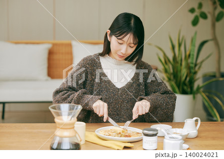 手作りの朝食を楽しむ一人暮らしの女性 140024021