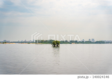 A small island in the middle of the Volga River in the vicinity of Kazan on a cloudy day. Tatarstan, Russia. A small island in the middle of the Volga River in the vicinity of Kazan on a cloudy day. Tatarstan, Russia. 140024146
