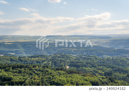 Layers of green mountains and hills in the haze during sunset. Panoramic View of Green hills and Meadow. 140024182