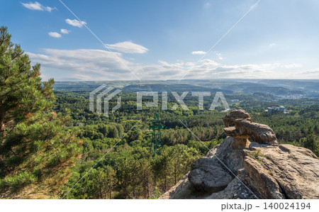 Majestic rocky cliffs and towering pine trees against blue sky. Majestic rocky cliffs and towering pine trees against blue sky. 140024194